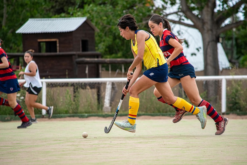 Woman playing hockey game outside